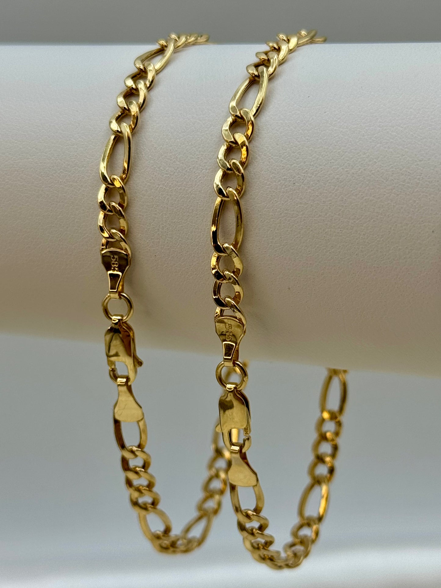 Figaro Gold chain bracelet on a white mannequin arm