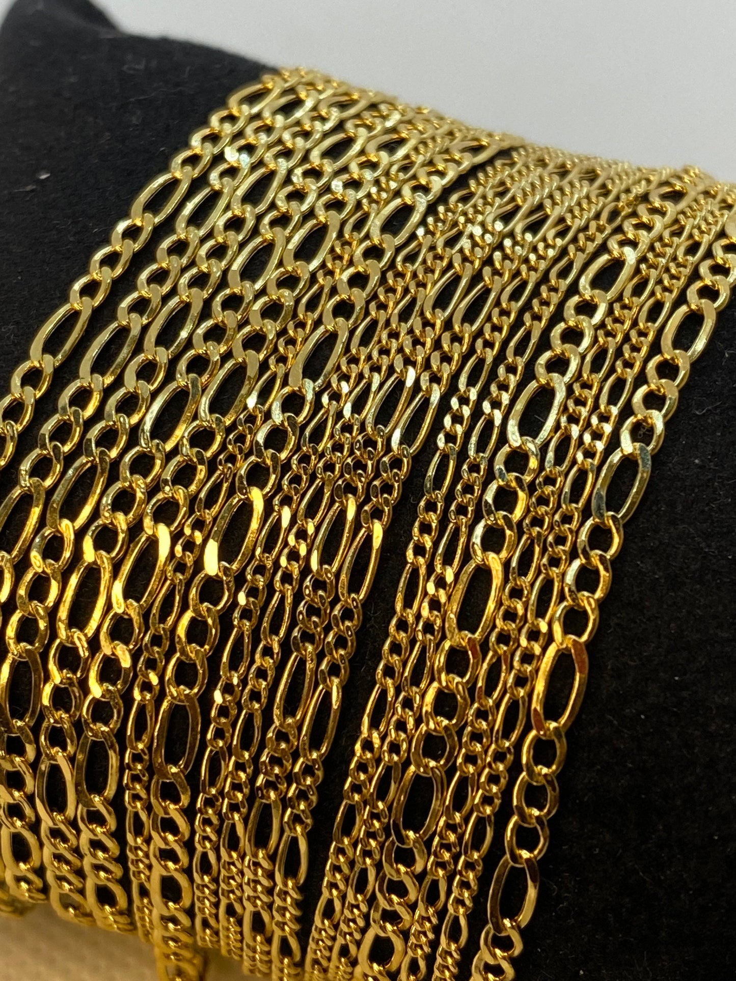 Figaro link in 18k Gold .