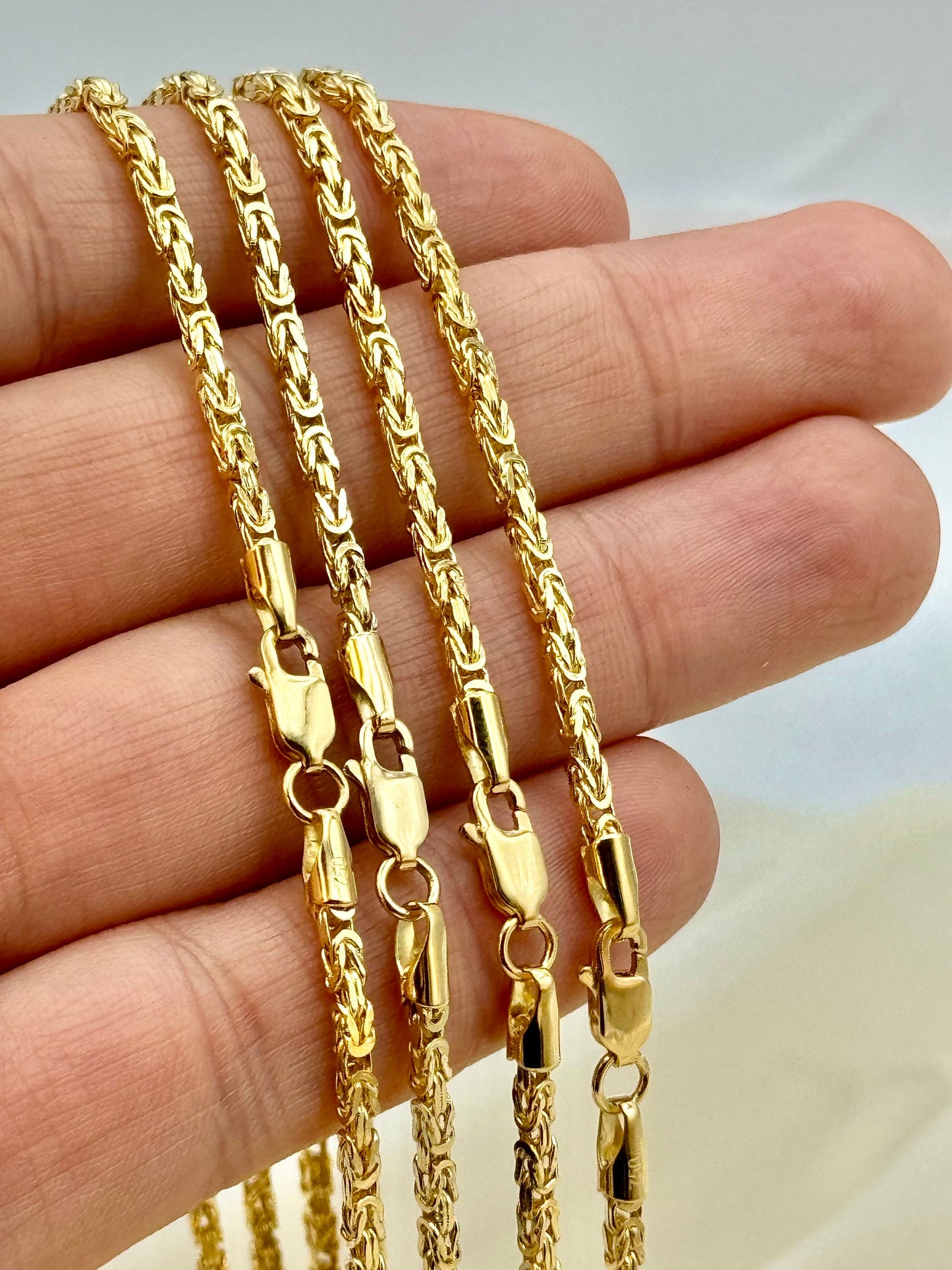 Byzantine chains on hand showing lobster clasp