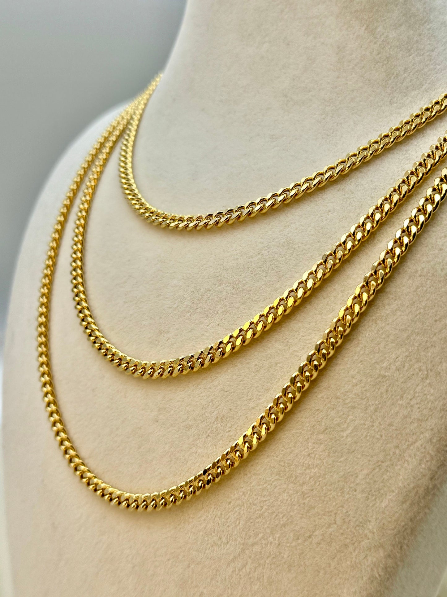 14K gold curb chain necklace displayed on a mannequin torso, with a golden color that resembles a real gold chain.