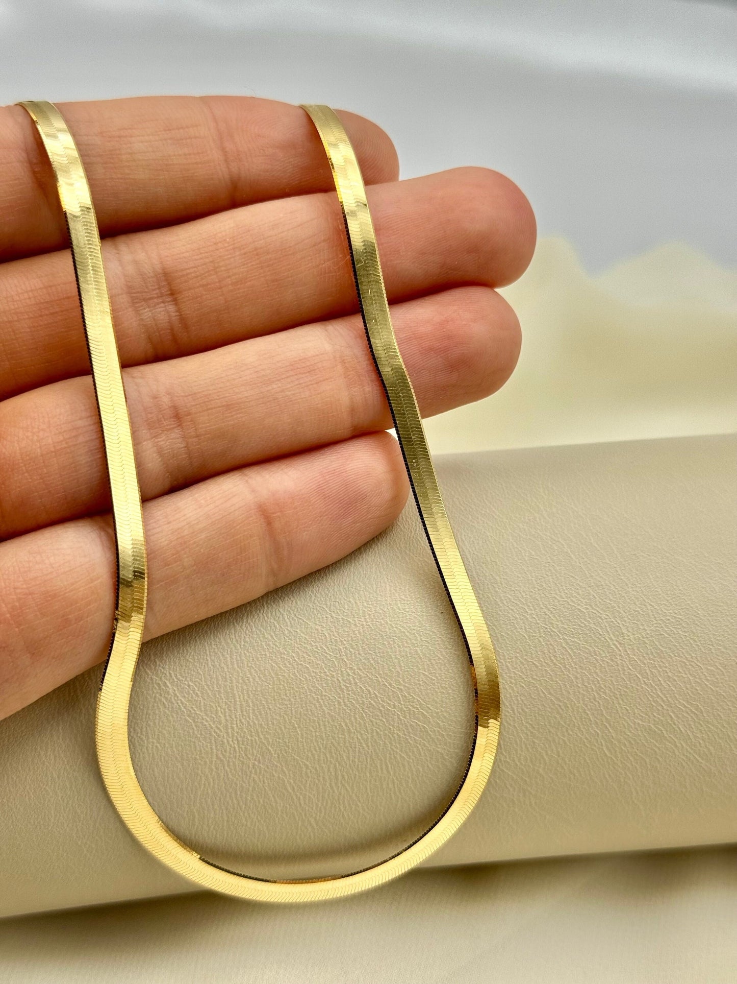 Gold snake chain on hand