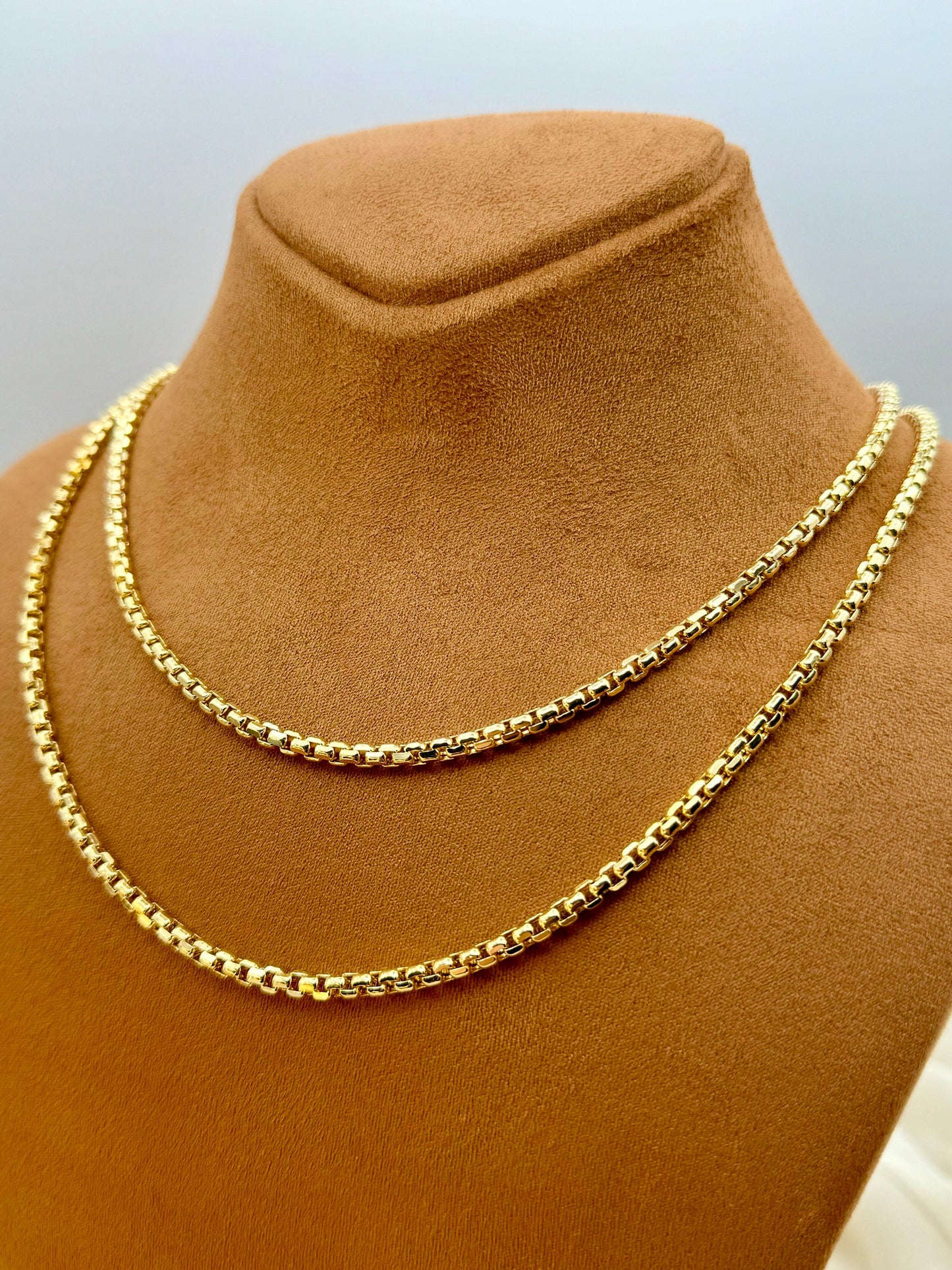 A 14K gold box chain necklace displayed on a tan mannequin torso.