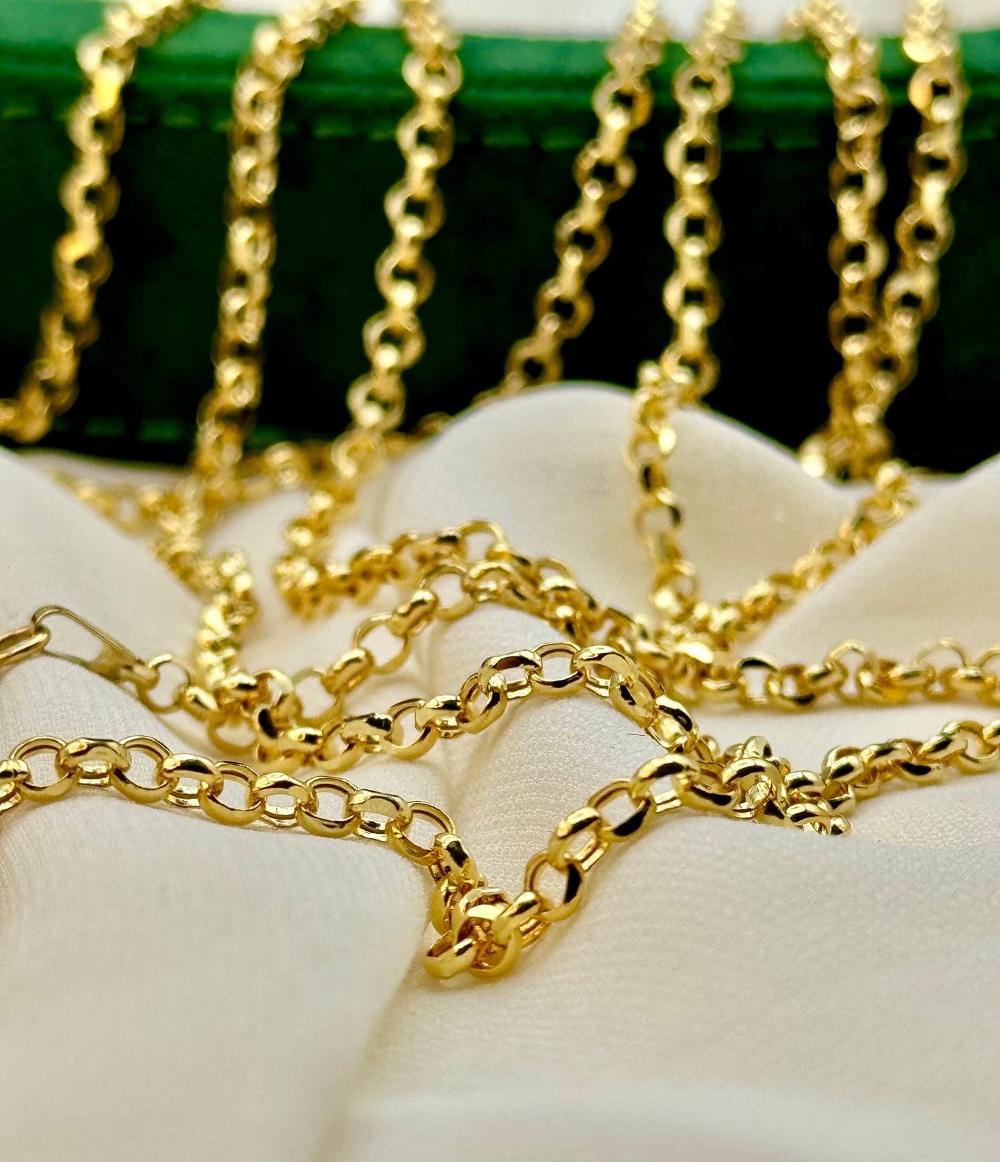 A series of 14K gold rolo chain necklaces with a secure spring lobster clasp, displayed on a white fabric surface.