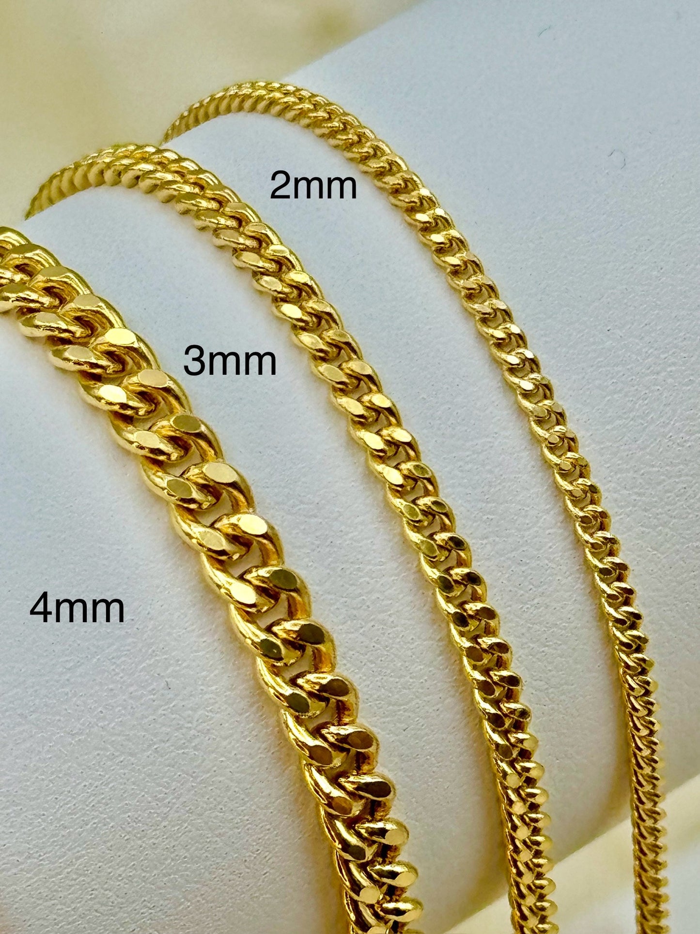14K gold curb chain necklaces displayed on a mannequin , with the necklace lengths indicated as 24 inches (6.58 grams) and 20 inches (5.