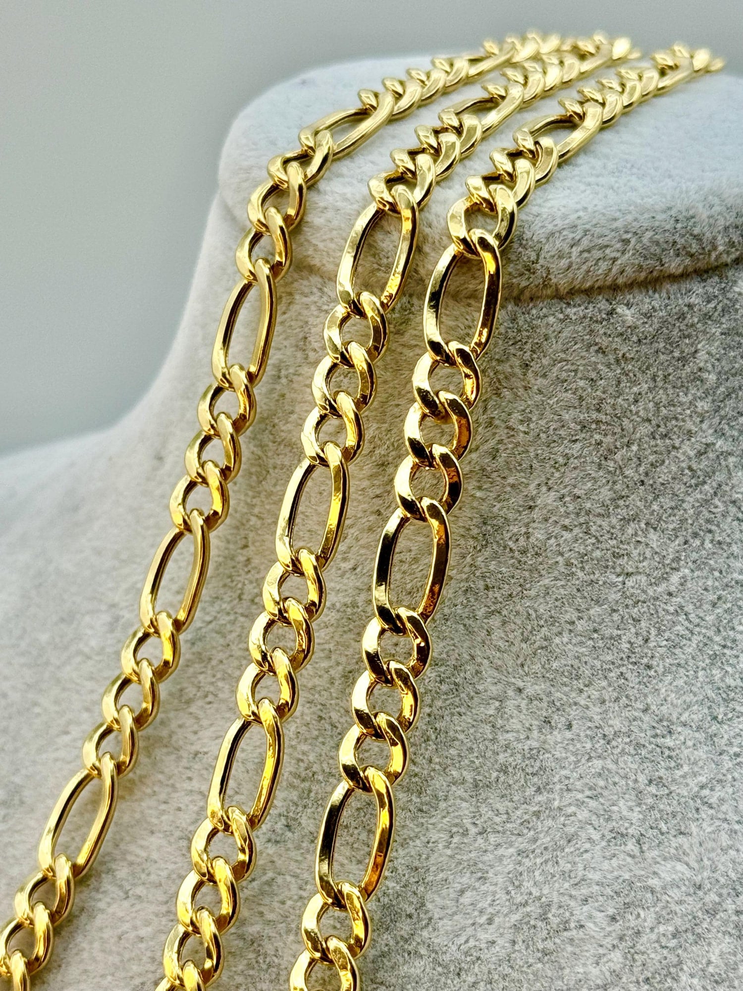 Gold Figaro chain.