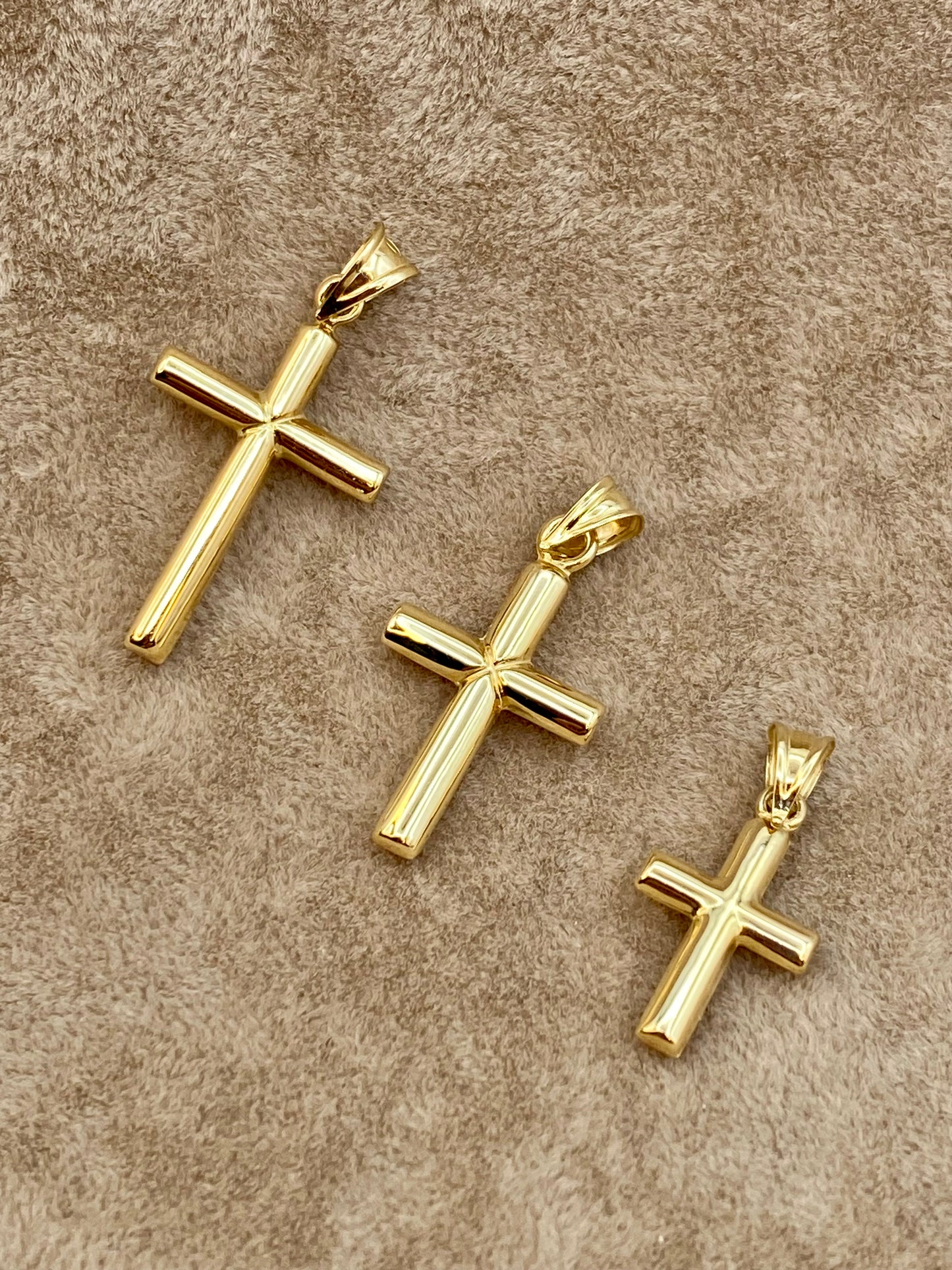 18k Gold Cross pendants on display.