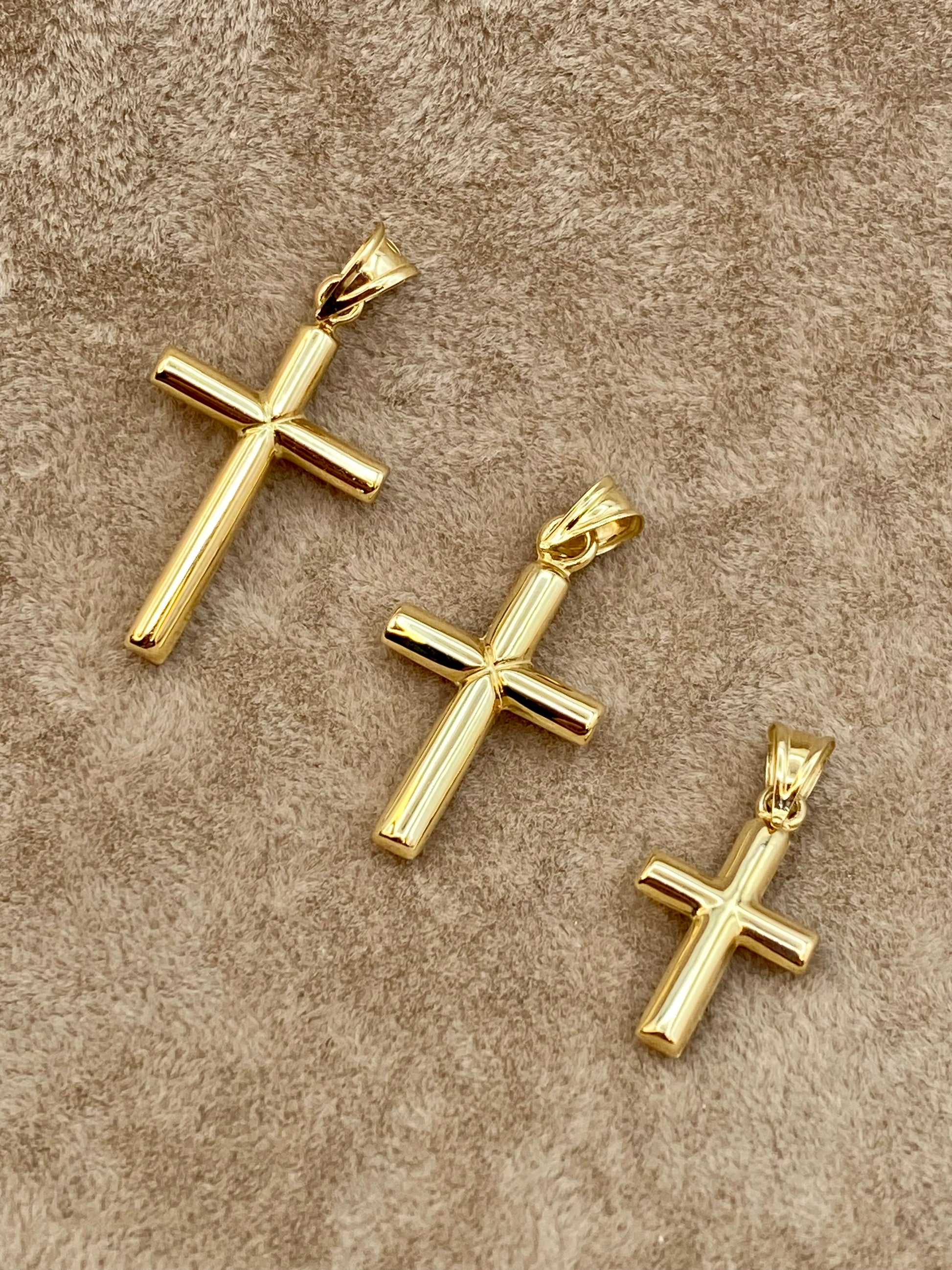 18k Gold Cross pendants on display.