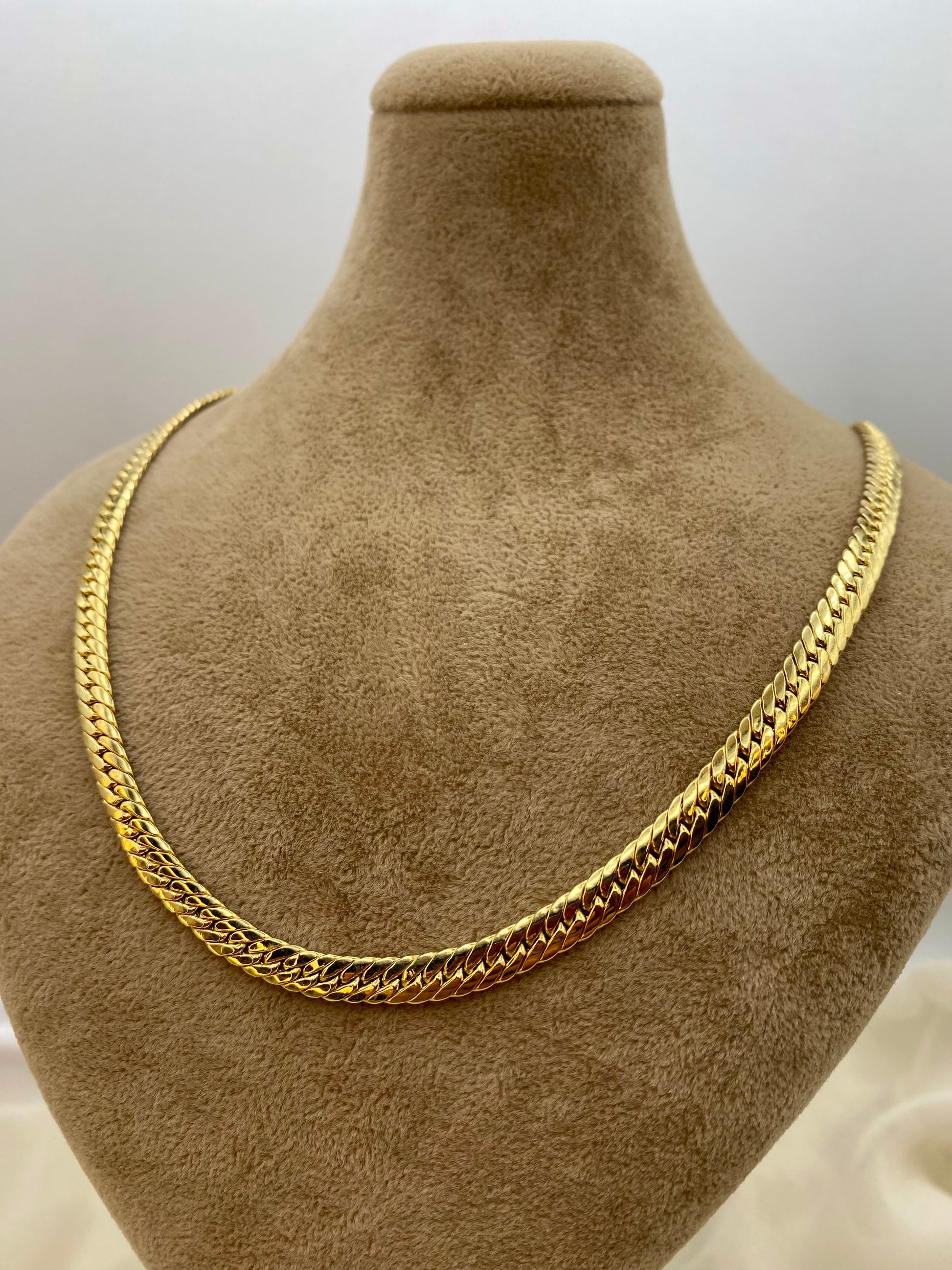 Gold double curb chain.