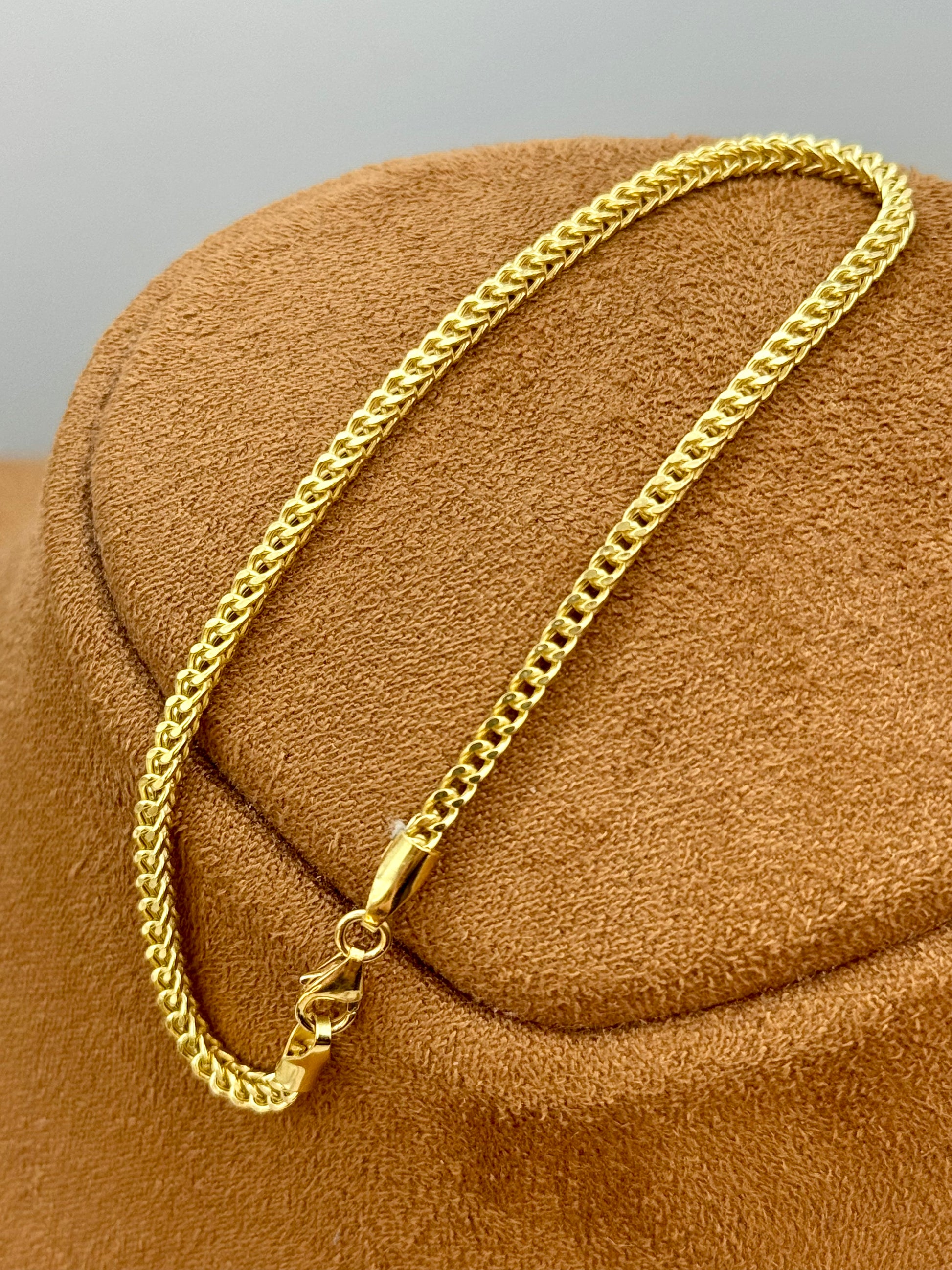 18k Gold Franco chain Bracelet on a brown textured surface