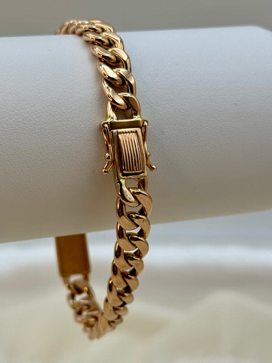 18k Rose Gold Curb chain bracelet on a white surface