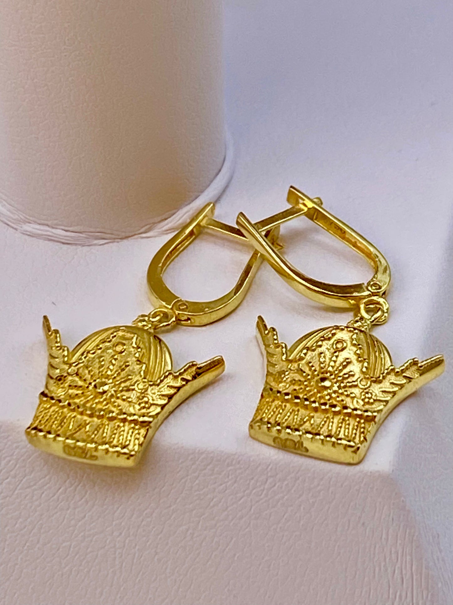 18k Gold earrings with intricate designs on a white background